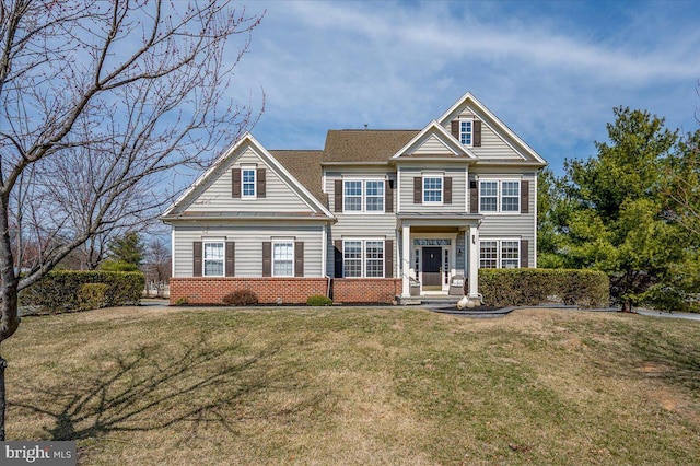 view of front facade featuring a front yard and brick siding