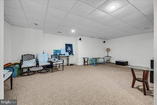 sitting room with a paneled ceiling, baseboards, and carpet floors