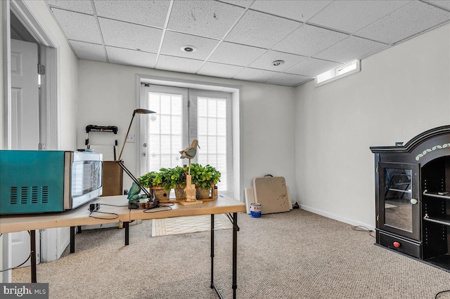 office area featuring a drop ceiling, carpet floors, and baseboards