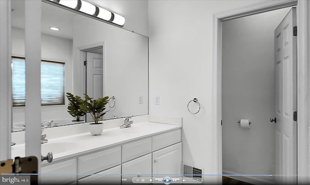 bathroom with double vanity and a sink