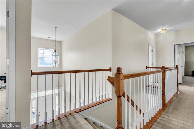 hallway featuring an upstairs landing