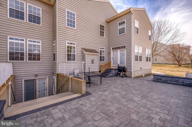 rear view of house featuring entry steps and a patio