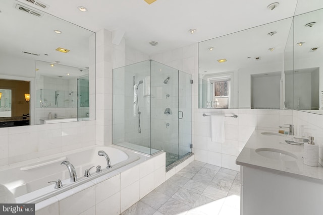 full bathroom featuring a garden tub, visible vents, a sink, and a stall shower