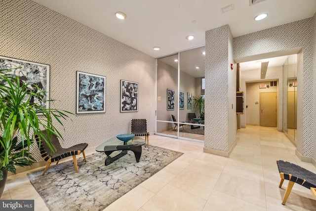 sitting room featuring recessed lighting and wallpapered walls