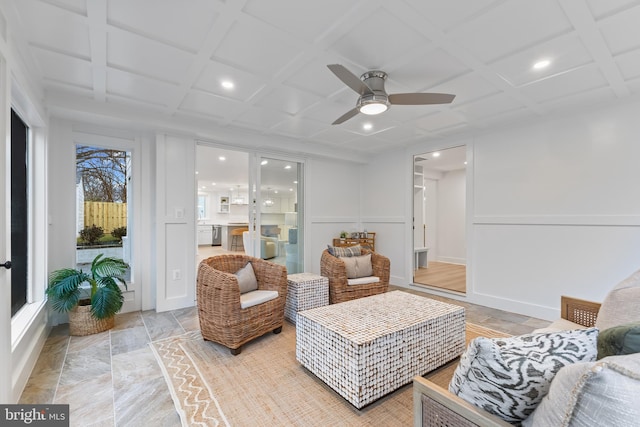 living area featuring coffered ceiling, a ceiling fan, a decorative wall, beam ceiling, and recessed lighting