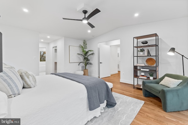 bedroom with a ceiling fan, connected bathroom, vaulted ceiling, light wood-style floors, and recessed lighting