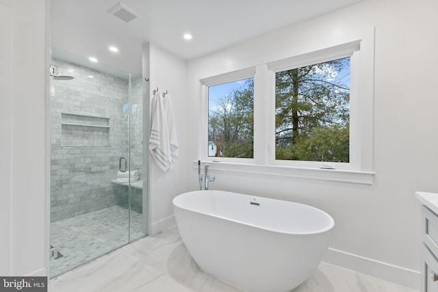 bathroom featuring a freestanding tub, recessed lighting, baseboards, marble finish floor, and a shower stall