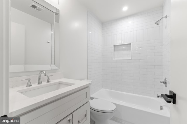 full bath with visible vents, bathing tub / shower combination, toilet, and vanity