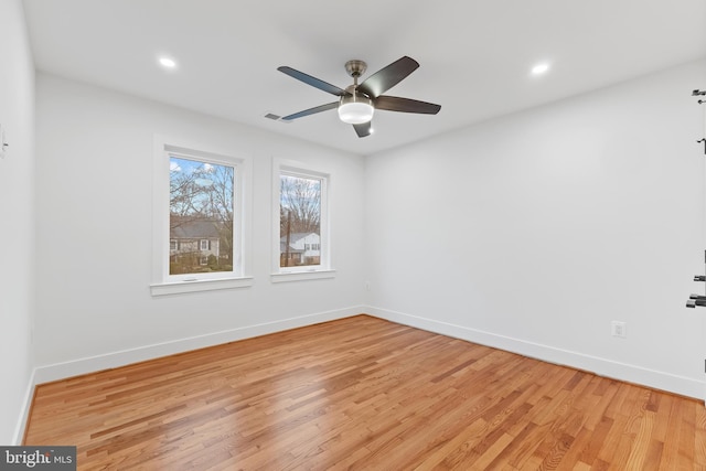 empty room featuring light wood-style floors, baseboards, and recessed lighting