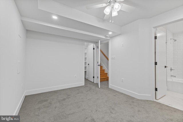 below grade area featuring baseboards, a ceiling fan, stairway, carpet floors, and recessed lighting