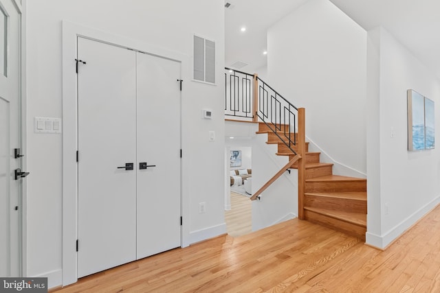 foyer featuring light wood-style flooring, recessed lighting, visible vents, baseboards, and stairway