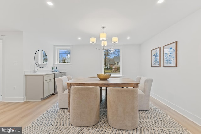 dining room with a healthy amount of sunlight, light wood-style floors, and recessed lighting