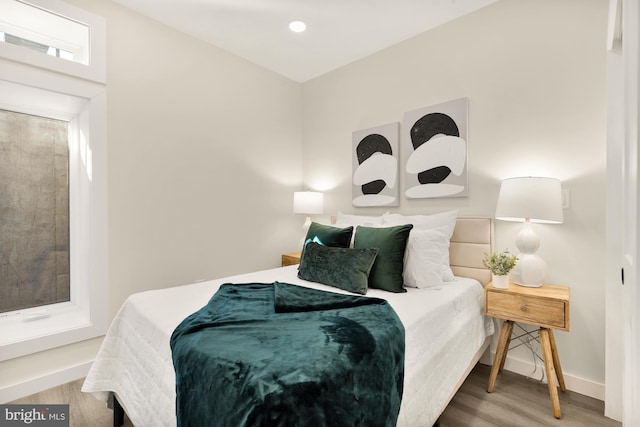 bedroom featuring wood finished floors and baseboards