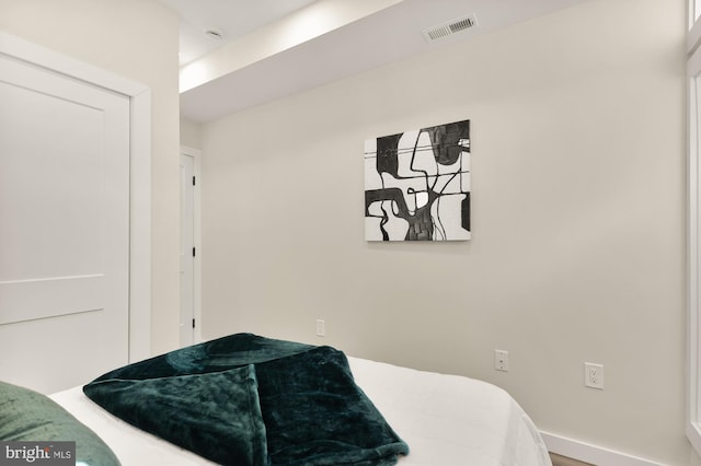 bedroom with visible vents and baseboards