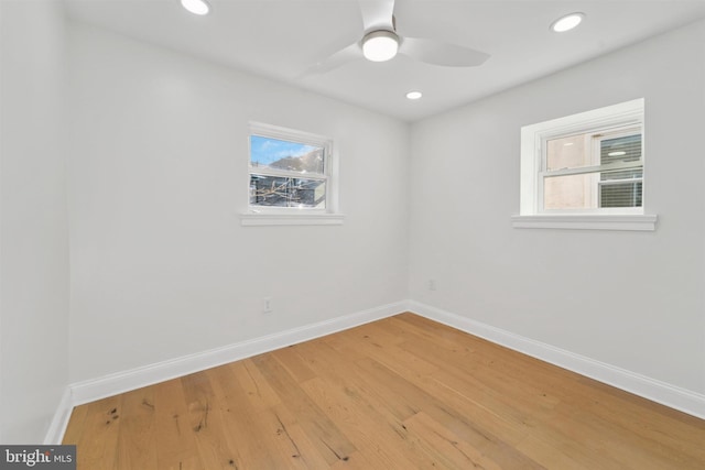 empty room with a ceiling fan, light wood-type flooring, baseboards, and recessed lighting