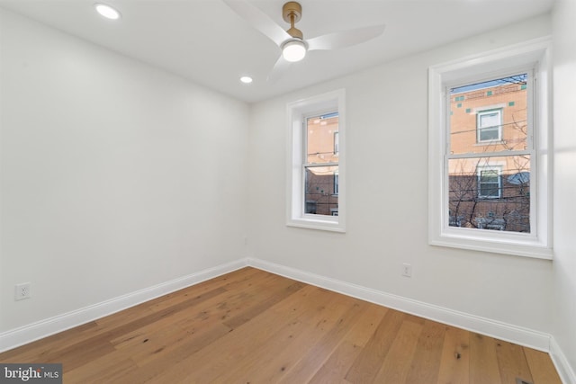 unfurnished room with hardwood / wood-style flooring, baseboards, a ceiling fan, and recessed lighting