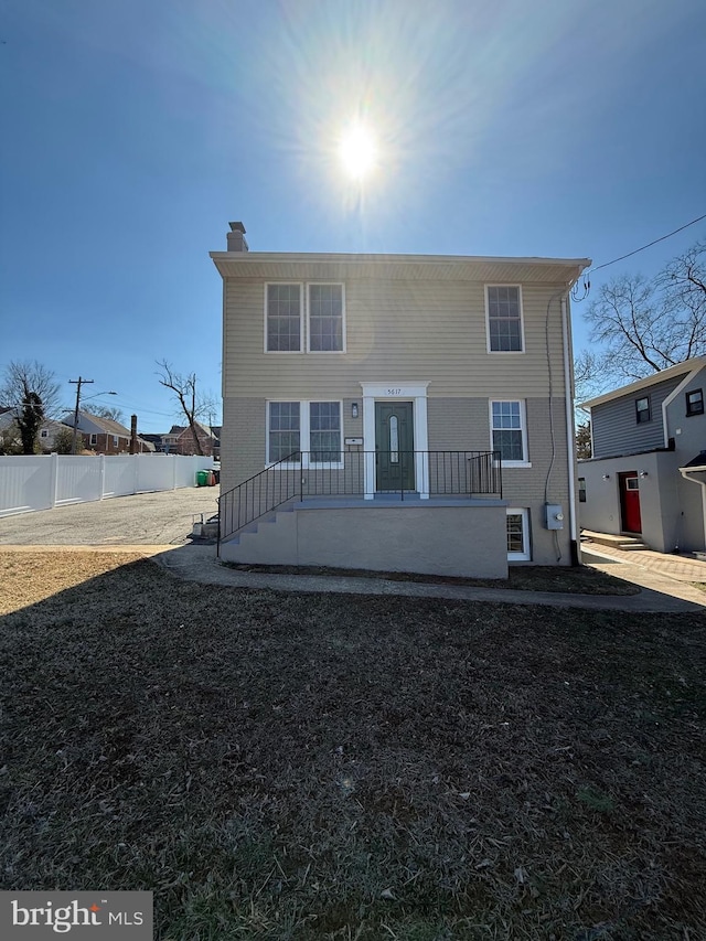 view of front of house with fence and a chimney