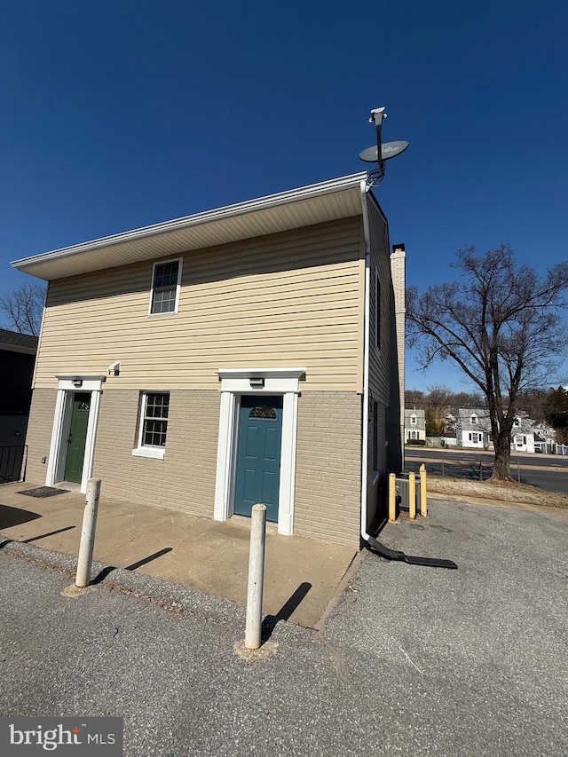 exterior space featuring brick siding