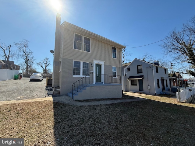 view of front of property with fence and a front yard