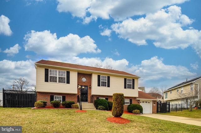 raised ranch with a garage, driveway, fence, and brick siding