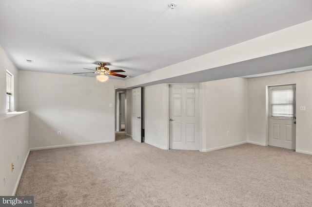 interior space with baseboards, carpet, and a healthy amount of sunlight