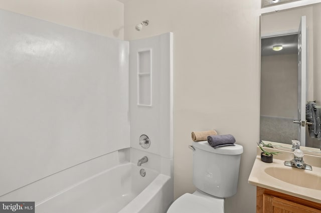 bathroom featuring toilet,  shower combination, and vanity