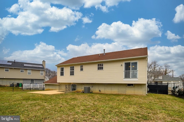 rear view of property featuring a patio area, a fenced backyard, and a lawn