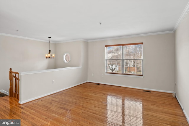 unfurnished room with light wood-style flooring, a notable chandelier, visible vents, baseboards, and crown molding