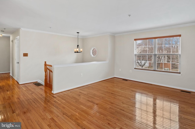 empty room featuring hardwood / wood-style floors and crown molding