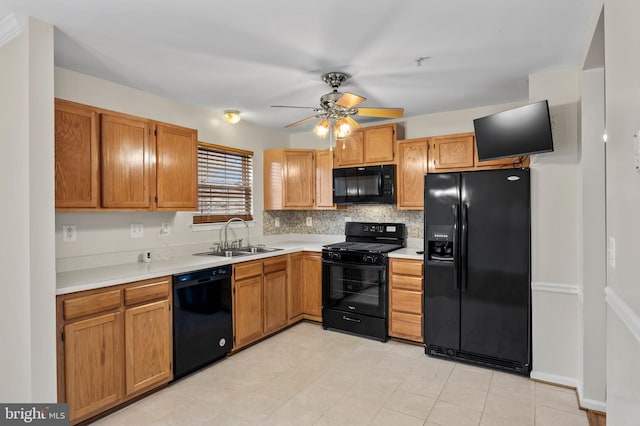 kitchen featuring light countertops, backsplash, a sink, ceiling fan, and black appliances