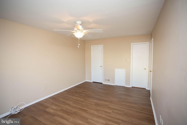 unfurnished bedroom featuring a ceiling fan, baseboards, and wood finished floors