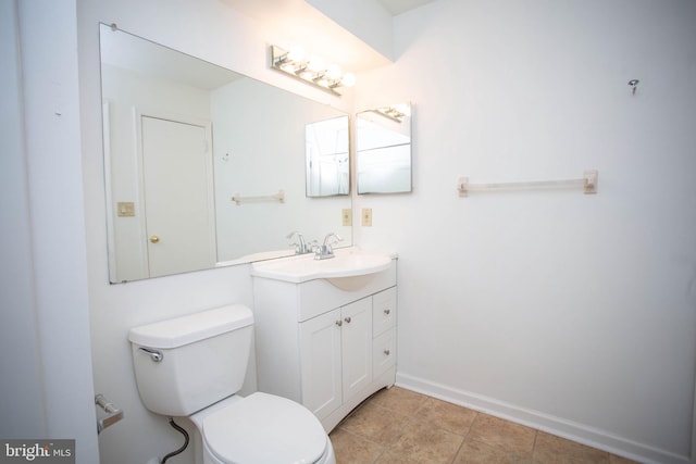 bathroom featuring tile patterned floors, vanity, toilet, and baseboards