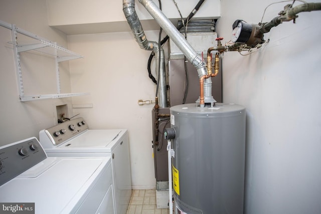 washroom with washing machine and dryer, laundry area, and water heater