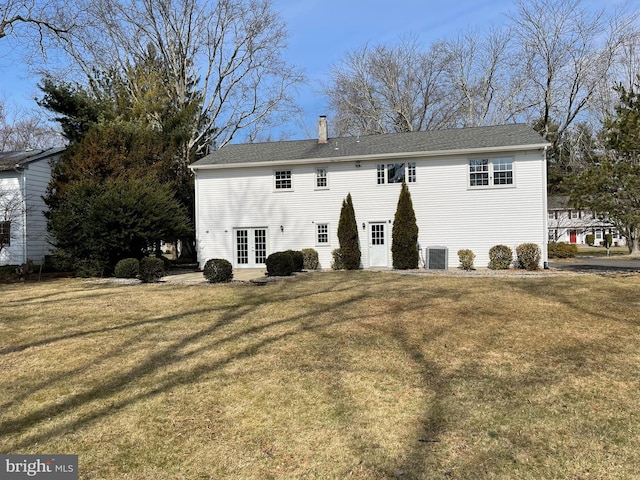 back of property with french doors, central AC, a lawn, and a chimney