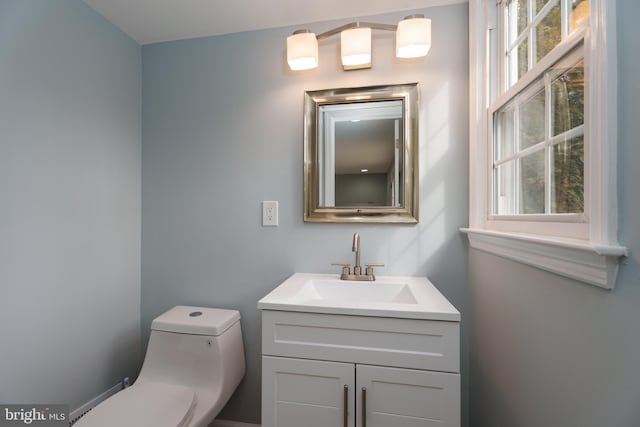 half bathroom featuring toilet and vanity