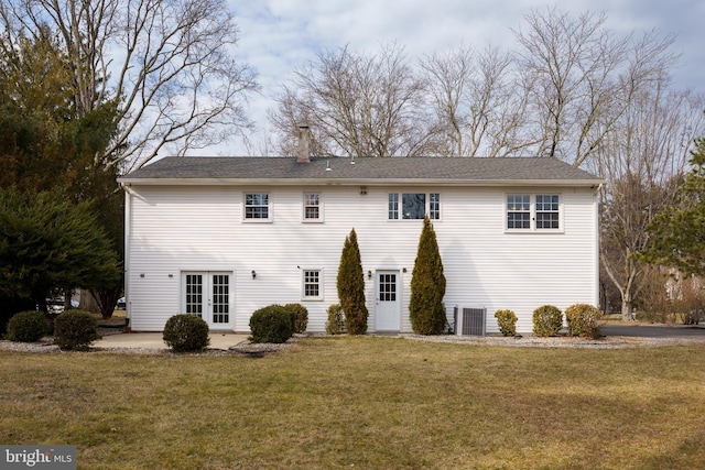 rear view of property featuring a patio area, central AC, a lawn, and french doors