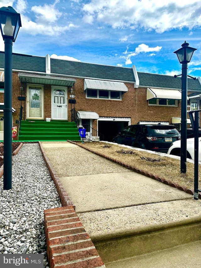 view of front of property featuring entry steps and brick siding