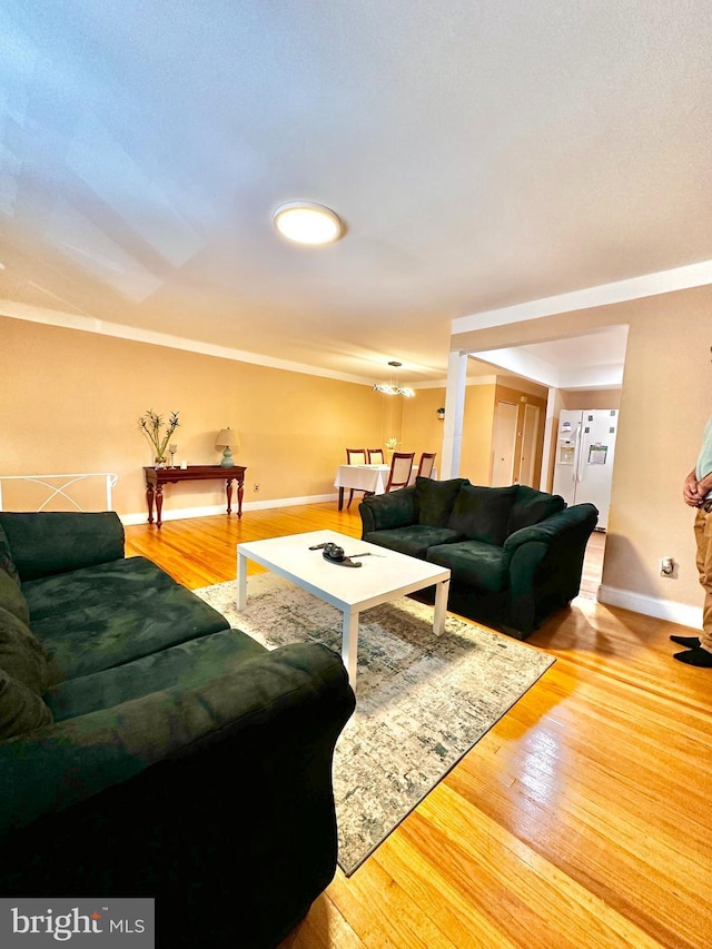 living room featuring baseboards and hardwood / wood-style flooring