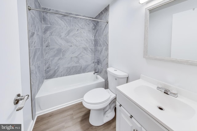 full bathroom featuring toilet, tub / shower combination, wood finished floors, and vanity