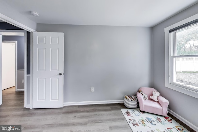 sitting room featuring baseboards and wood finished floors