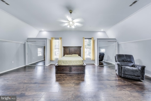 bedroom featuring dark wood-style floors, visible vents, and vaulted ceiling