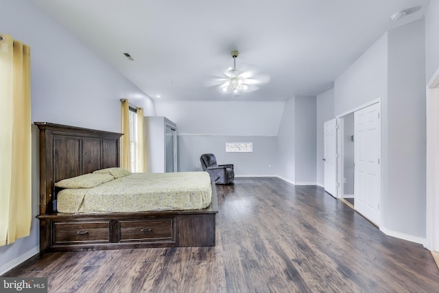 bedroom with dark wood-style floors, lofted ceiling, baseboards, and a ceiling fan