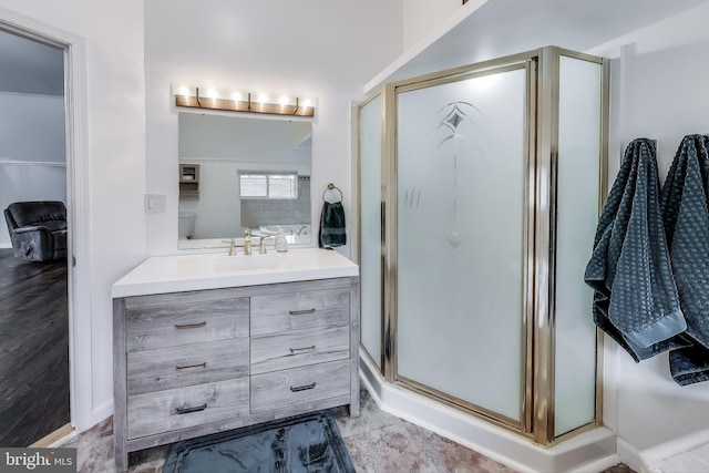 full bathroom featuring a stall shower and vanity