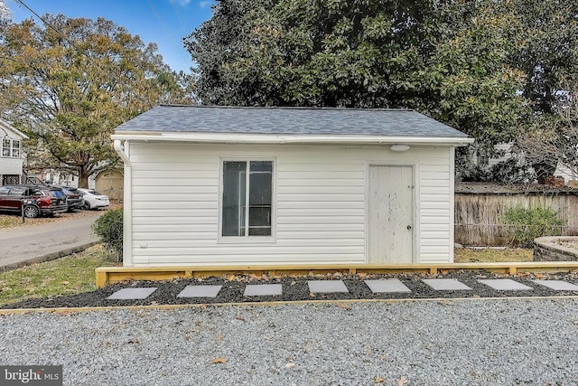 view of outbuilding with an outdoor structure and fence