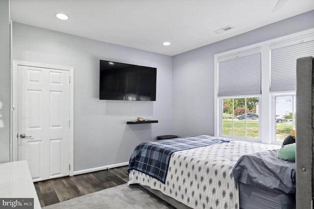 bedroom featuring recessed lighting, wood finished floors, visible vents, and baseboards