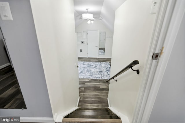 stairway with lofted ceiling, a ceiling fan, and wood finished floors