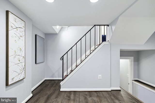 stairs with baseboards and wood finished floors