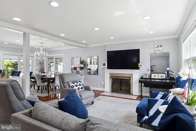 living room with a fireplace with flush hearth, recessed lighting, crown molding, and wood finished floors