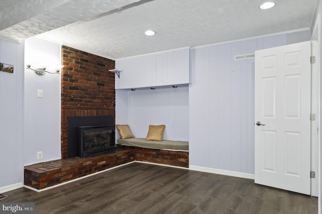 mudroom featuring crown molding, a fireplace, baseboards, and wood finished floors