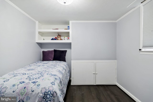 bedroom featuring baseboards, ornamental molding, and wood finished floors